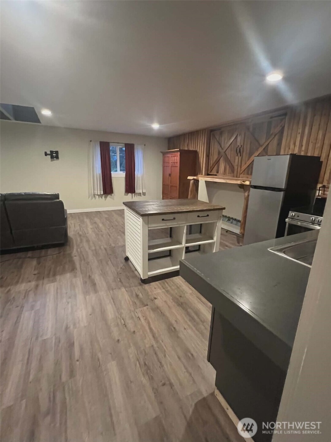 7516 Skinner Road Granite Falls, WA 98252 - Photo 30 of 40 a living room with furniture and a wooden floor