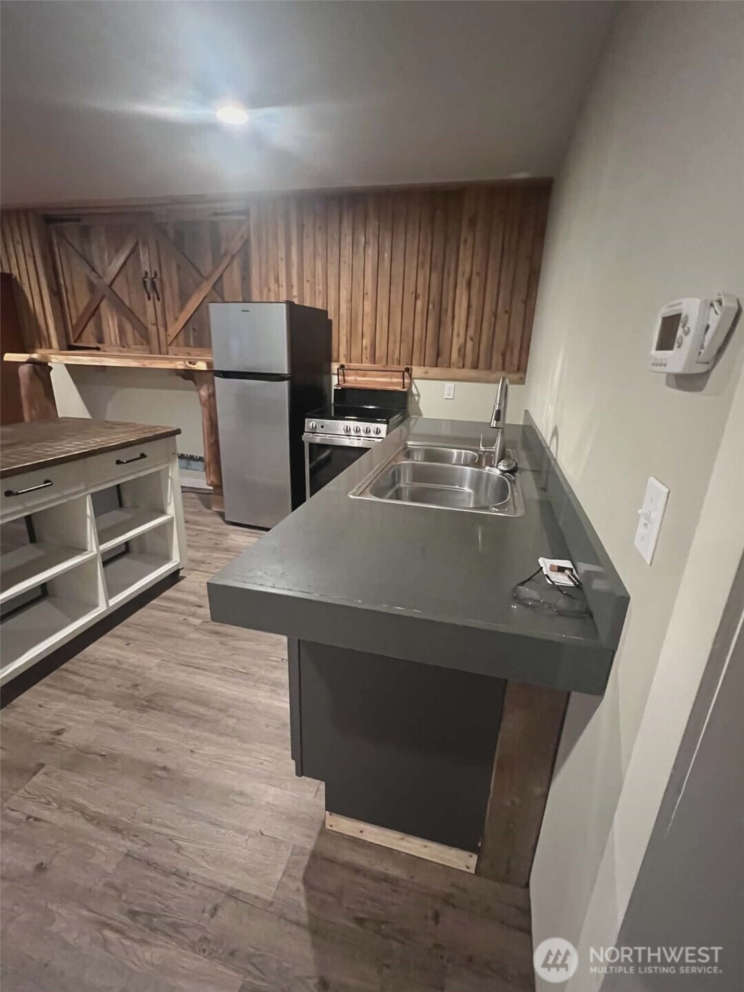 7516 Skinner Road Granite Falls, WA 98252 - Photo 31 of 40 a open kitchen with kitchen island a stove and a refrigerator