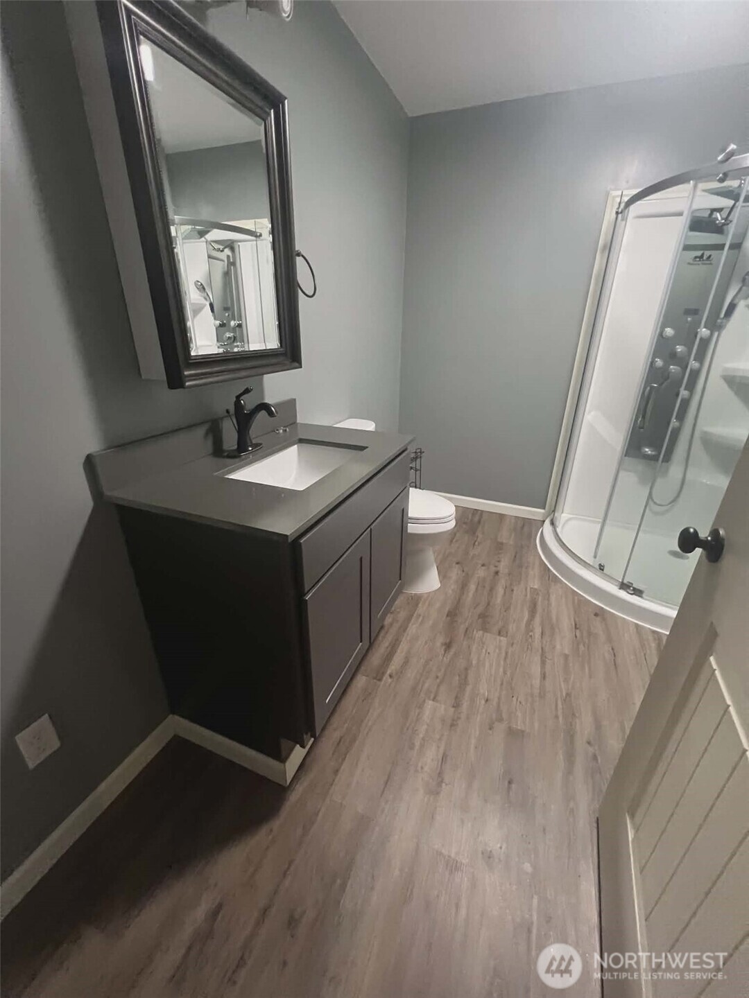 7516 Skinner Road Granite Falls, WA 98252 - Photo 32 of 40 a bathroom with a toilet sink and mirror