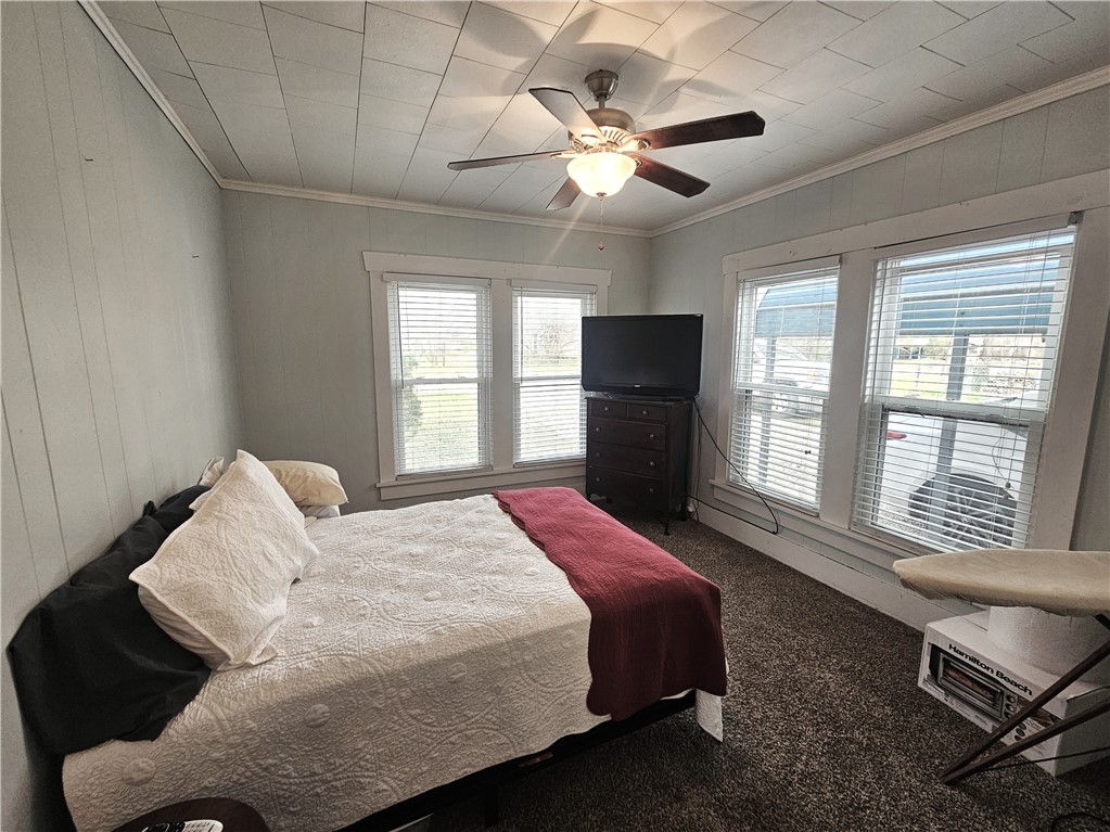706 West Navasota Street Groesbeck, TX 76642 - Photo 11 of 18 a spacious bedroom with a bed and a large window