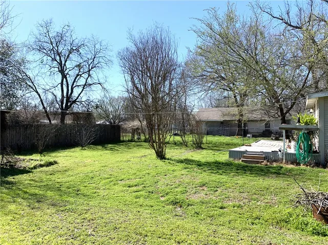 a view of a house with a yard and sitting area