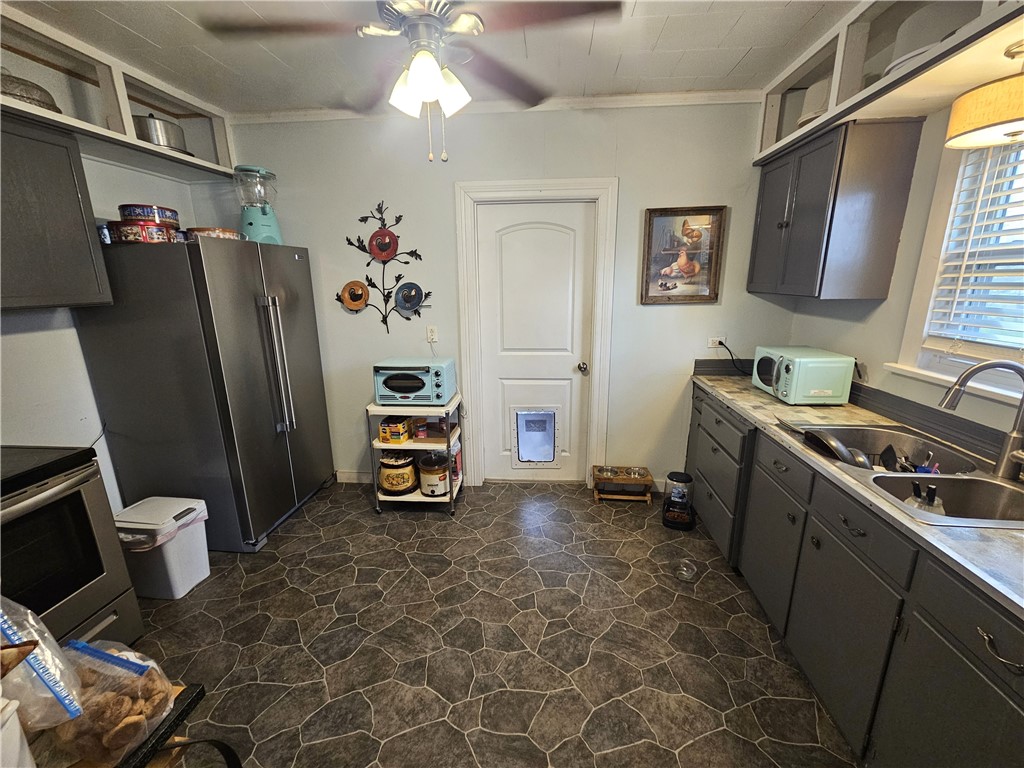 706 West Navasota Street Groesbeck, TX 76642 - Photo 5 of 18 a view of a kitchen with fridge and workspace