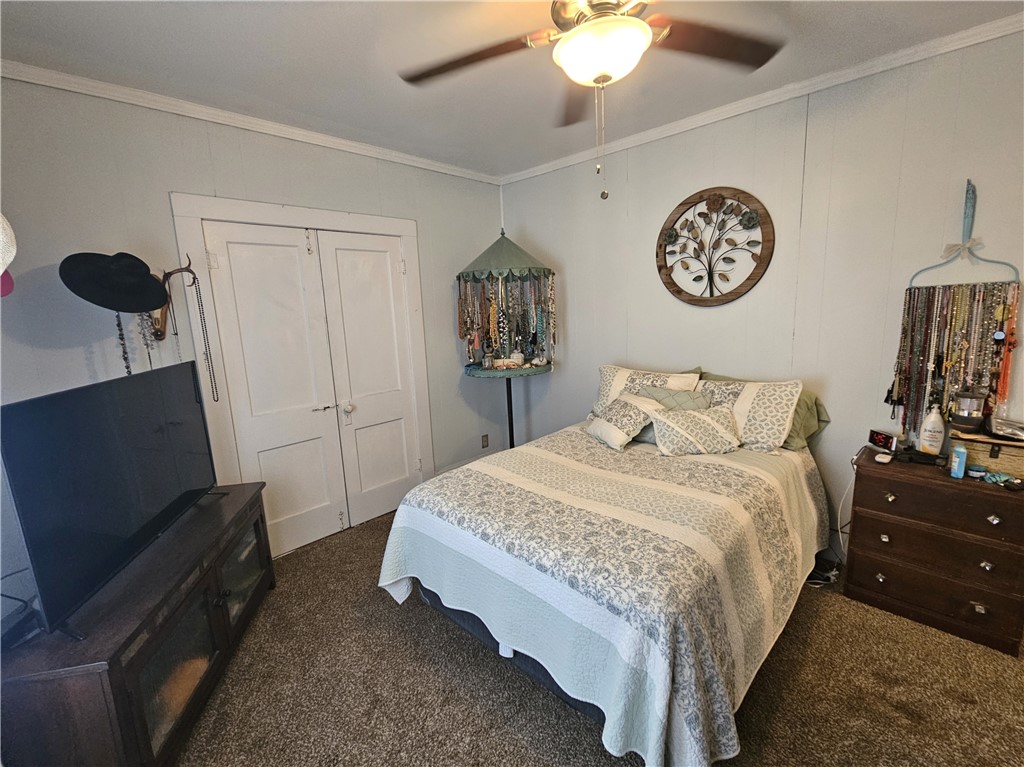 706 West Navasota Street Groesbeck, TX 76642 - Photo 10 of 18 a bedroom with a bed and a chandelier