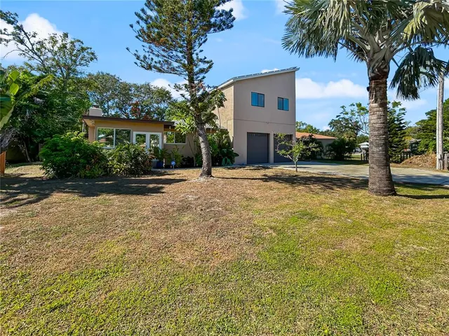 a front view of a house with a yard and a garage