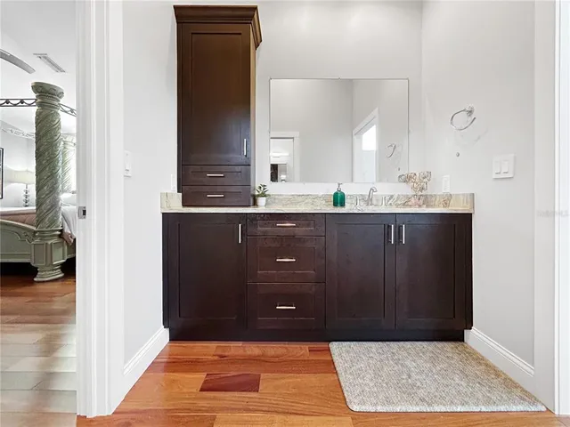 a bathroom with a sink a vanity and a mirror