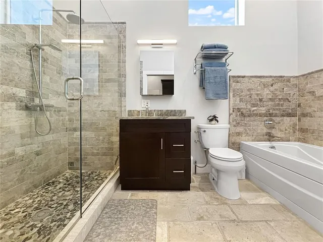 a bathroom with a toilet sink and shower