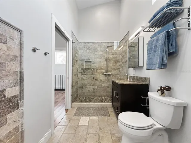 a bathroom with a toilet a sink and shower
