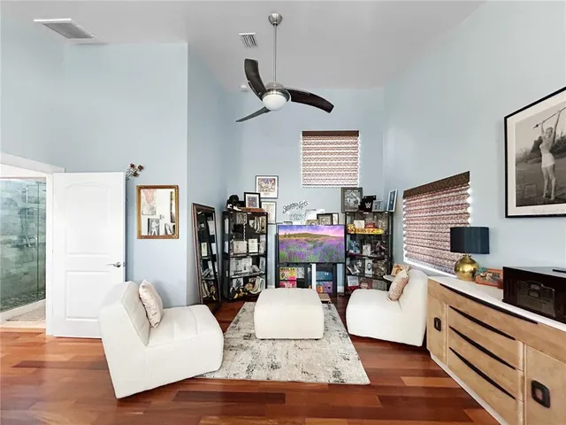 a living room with furniture and a wooden floor
