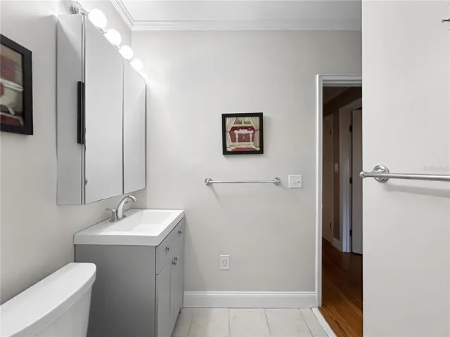 a bathroom with a toilet a sink and mirror