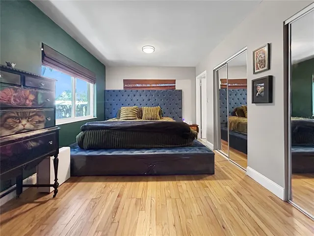 a bedroom with a bed and a large window