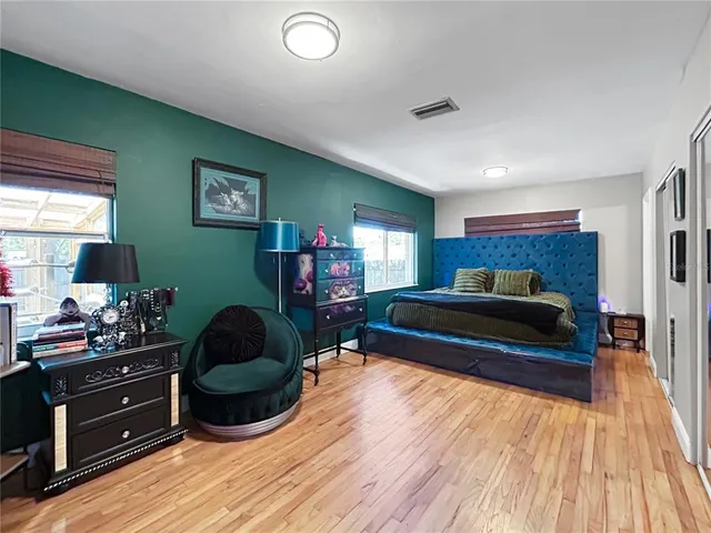 a bedroom with a bed and a mirror