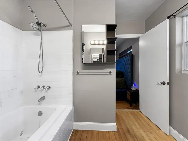 a bathroom with a bathtub and a shower