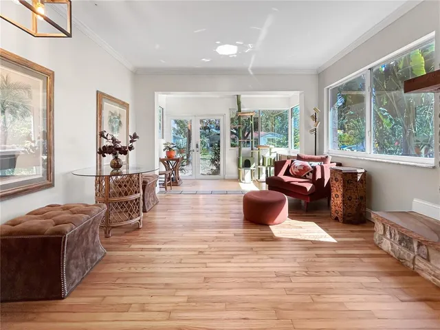 a living room with furniture and large windows