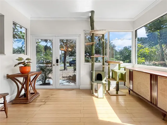 a work room with furniture water view and a floor to ceiling window