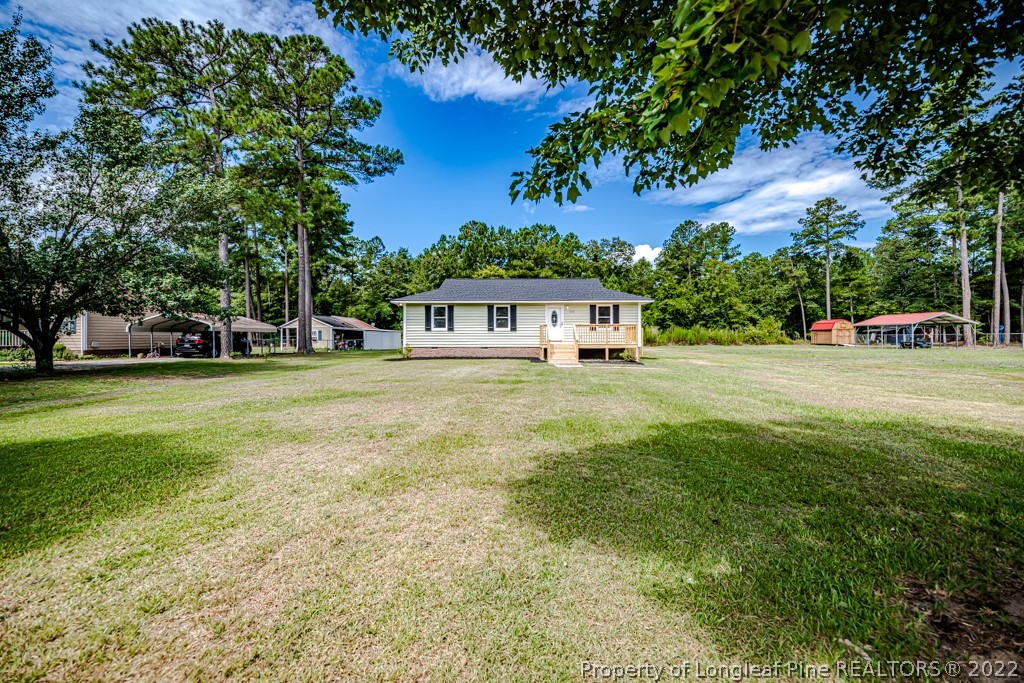 192 Cypress Road Cameron, NC 28326 - Photo 3 of 26 a house view with swimming pool in front of it