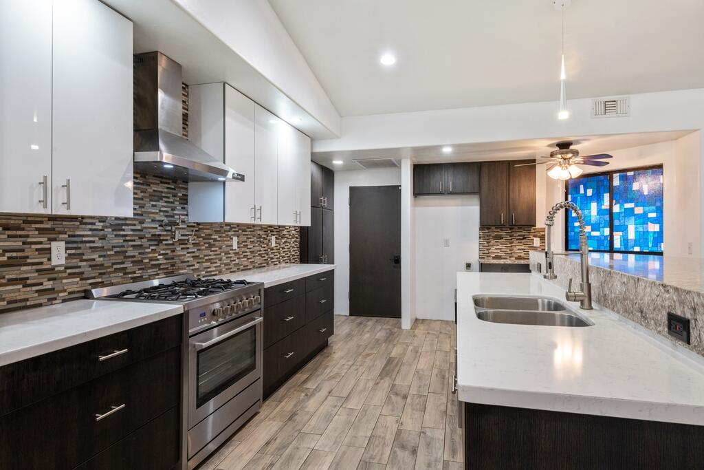 67425 Medano Road Cathedral City, CA 92234 - Photo 5 of 17 a kitchen with stainless steel appliances granite countertop a sink stove and refrigerator