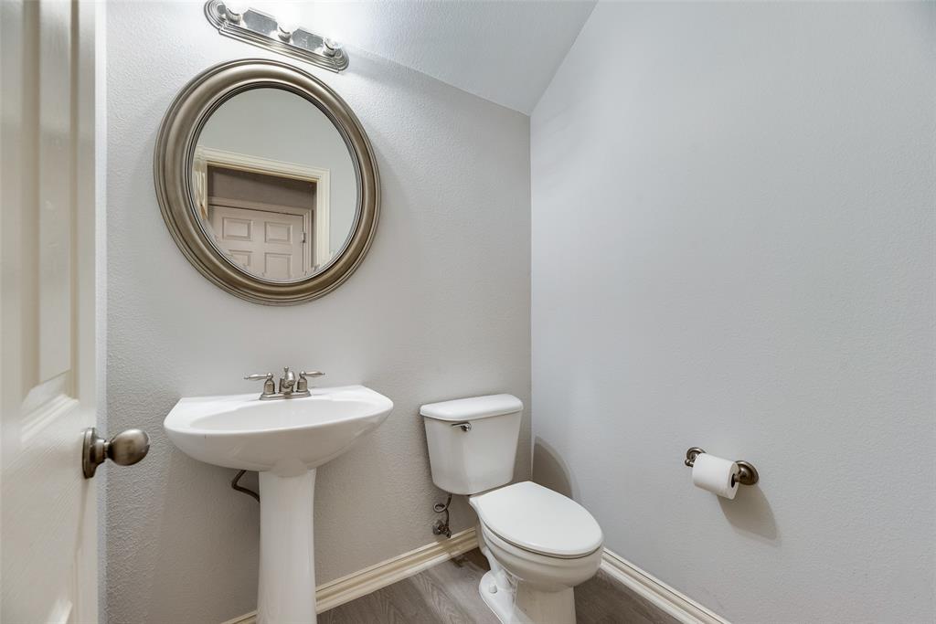 2320 Durango Ridge Drive Bedford, TX 76021 - Photo 8 of 21 a bathroom with a sink a toilet and a mirror