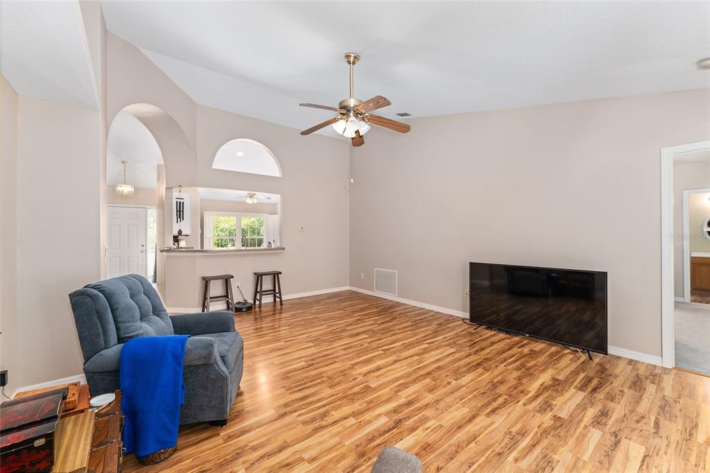 2121 Vindale Road Tavares, FL 32778 - Photo 14 of 37 a bedroom with a bed and a chair