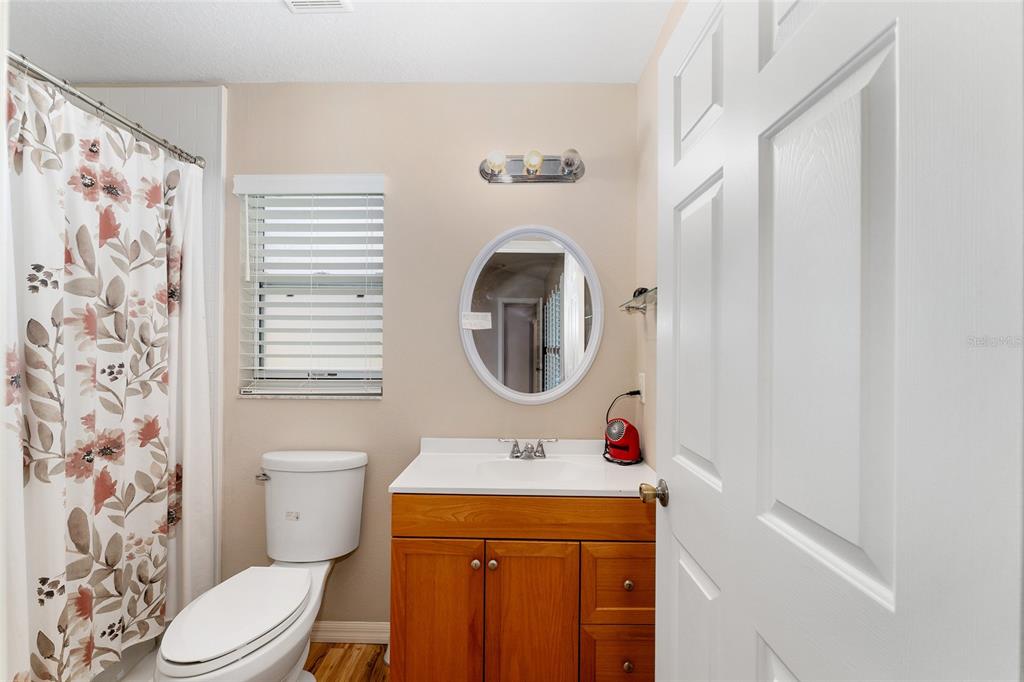 2121 Vindale Road Tavares, FL 32778 - Photo 23 of 37 a bathroom with a sink and a mirror