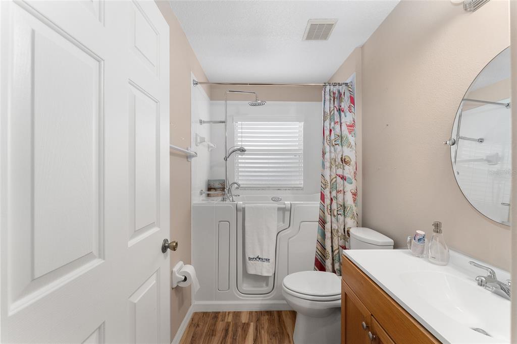 2121 Vindale Road Tavares, FL 32778 - Photo 27 of 37 a bathroom with a sink toilet vanity and shower