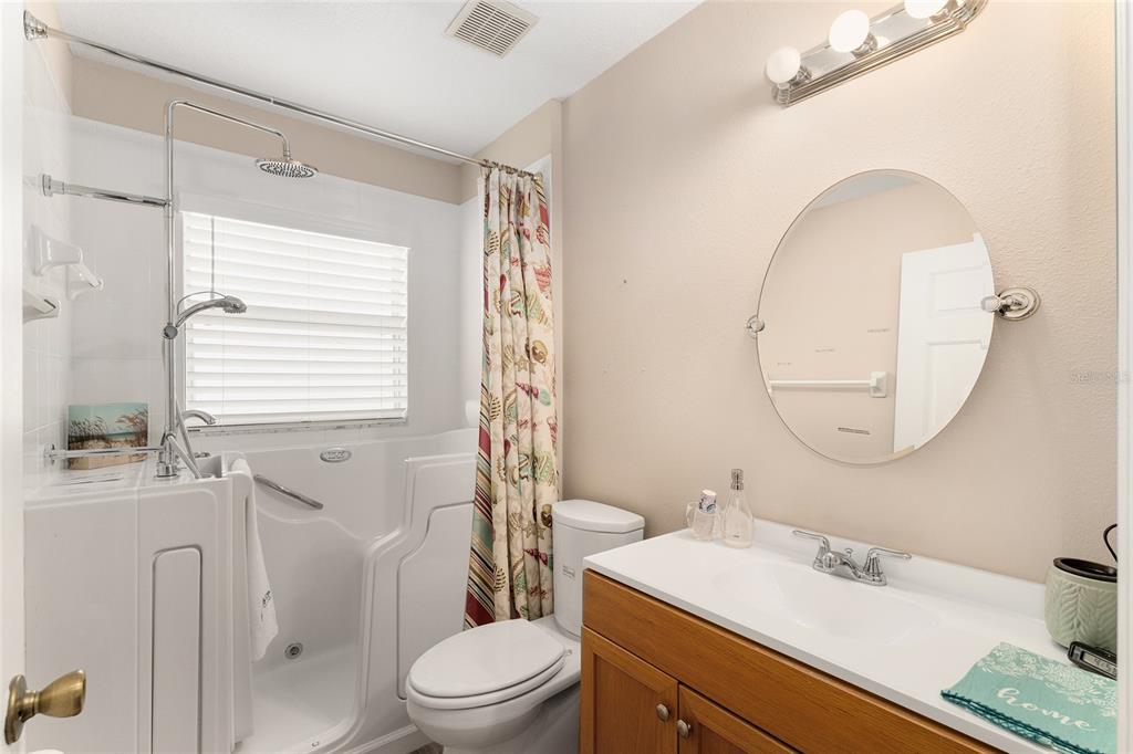 2121 Vindale Road Tavares, FL 32778 - Photo 28 of 37 a bathroom with a sink toilet a mirror and tub