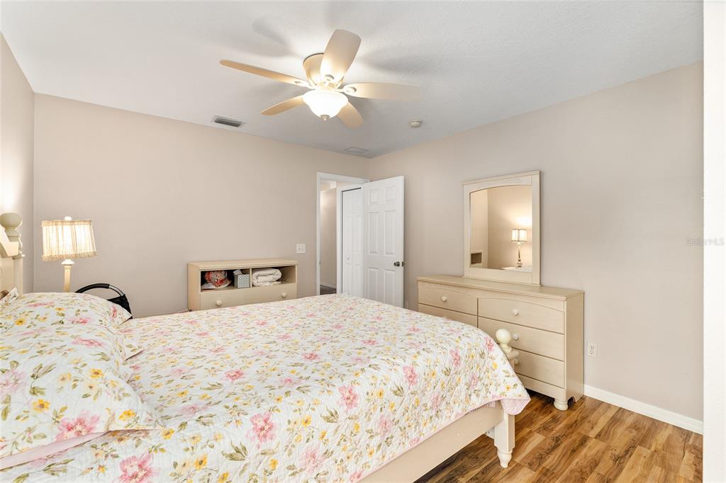 2121 Vindale Road Tavares, FL 32778 - Photo 31 of 37 a bedroom with a bed and a chandelier