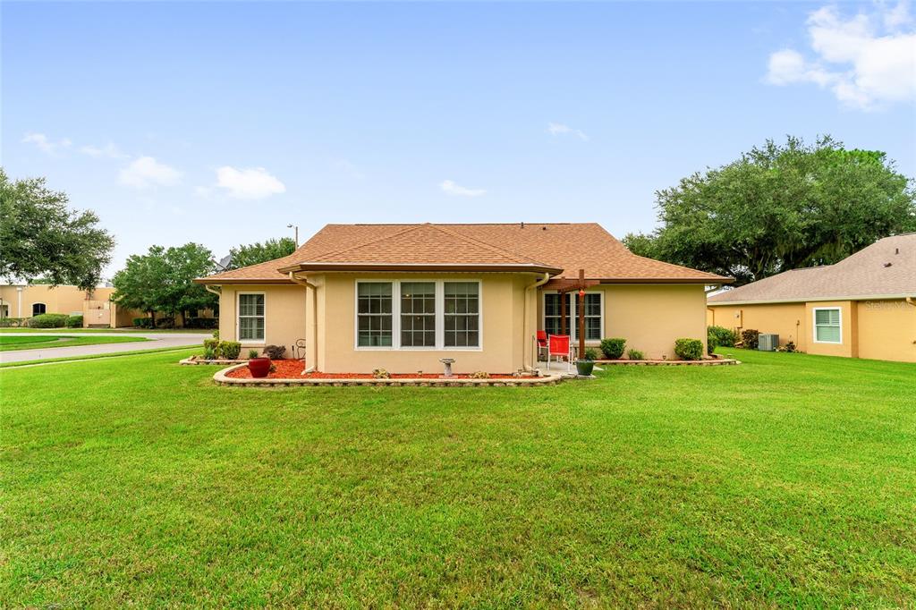2121 Vindale Road Tavares, FL 32778 - Photo 34 of 37 a view of a house with a backyard