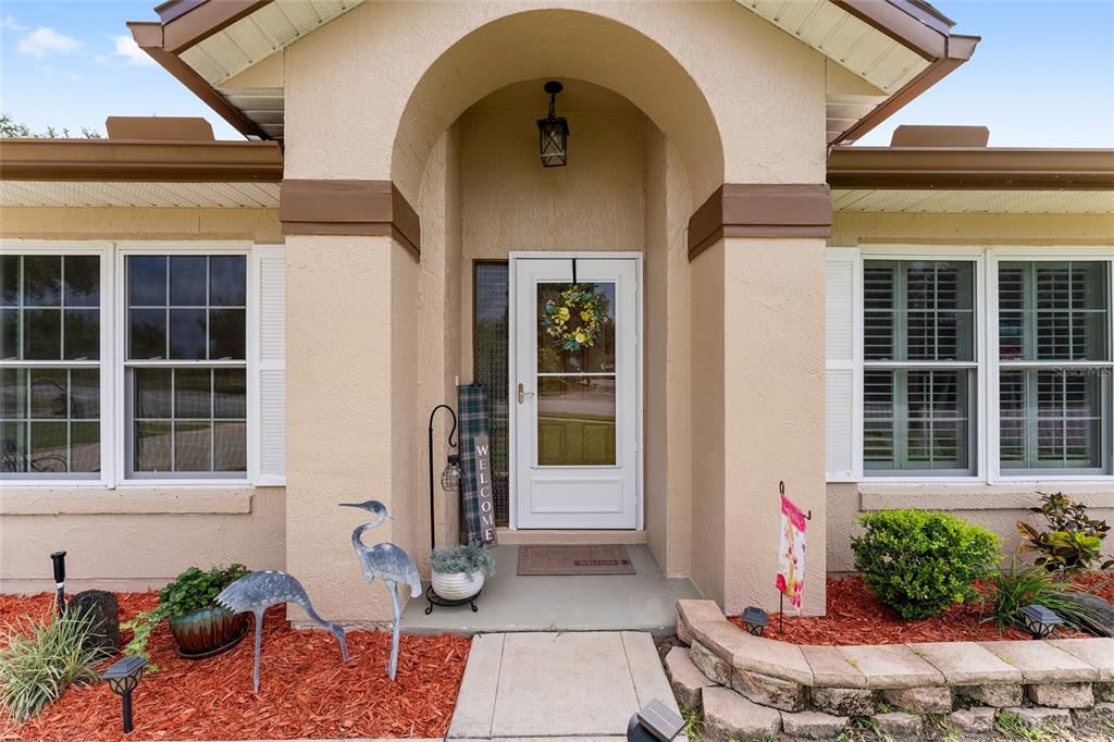 2121 Vindale Road Tavares, FL 32778 - Photo 4 of 37 a front view of a house with a garden