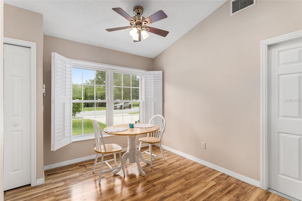 2121 Vindale Road Tavares, FL 32778 - Photo 7 of 37 a workspace with wooden floor and a window