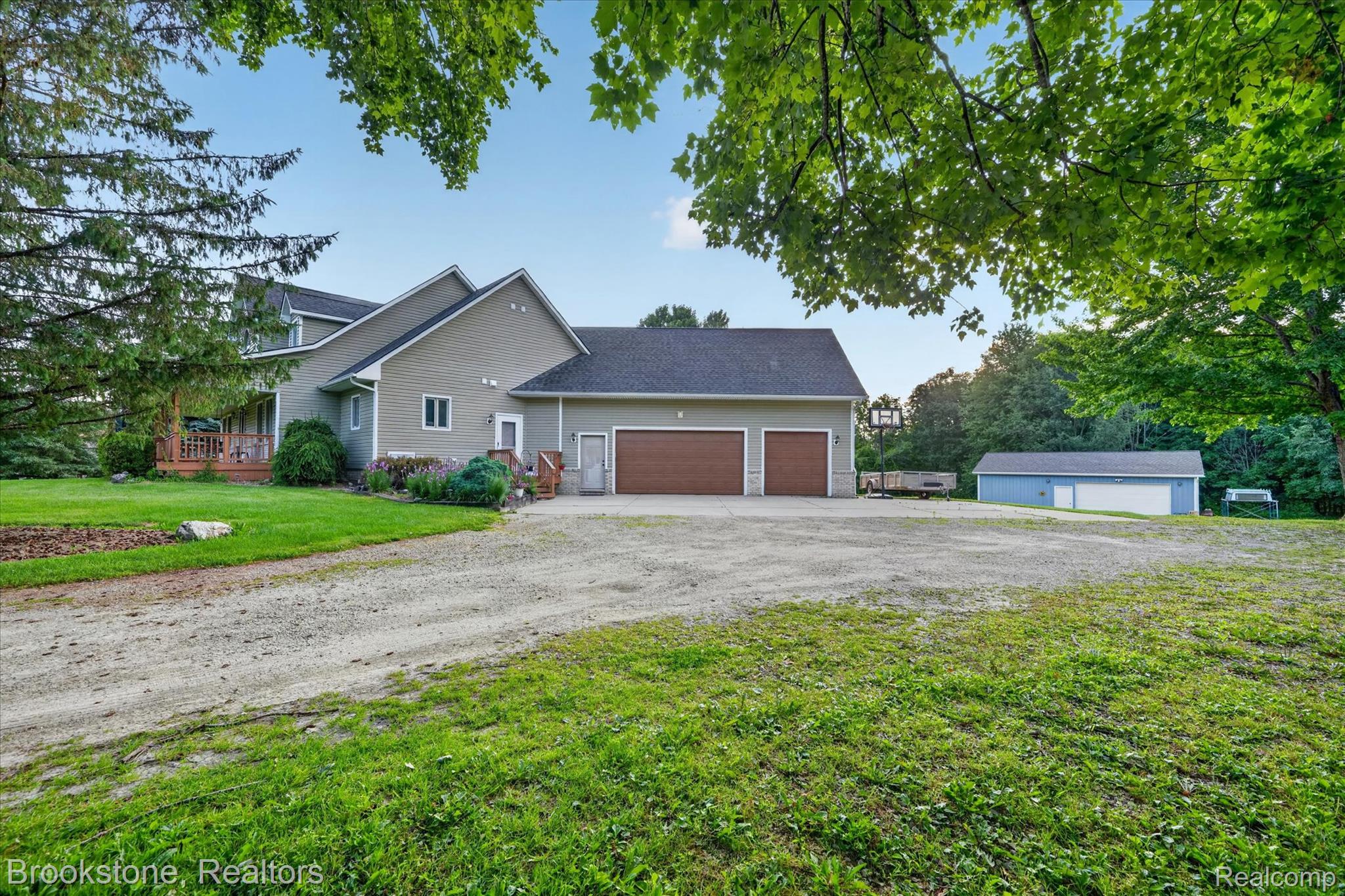 5163 Country Squire Road Dryden, MI 48428 - Photo 8 of 64 Expansive gravel driveway providing extensive parking and access to a two-car attached garage and a detached two-car garage