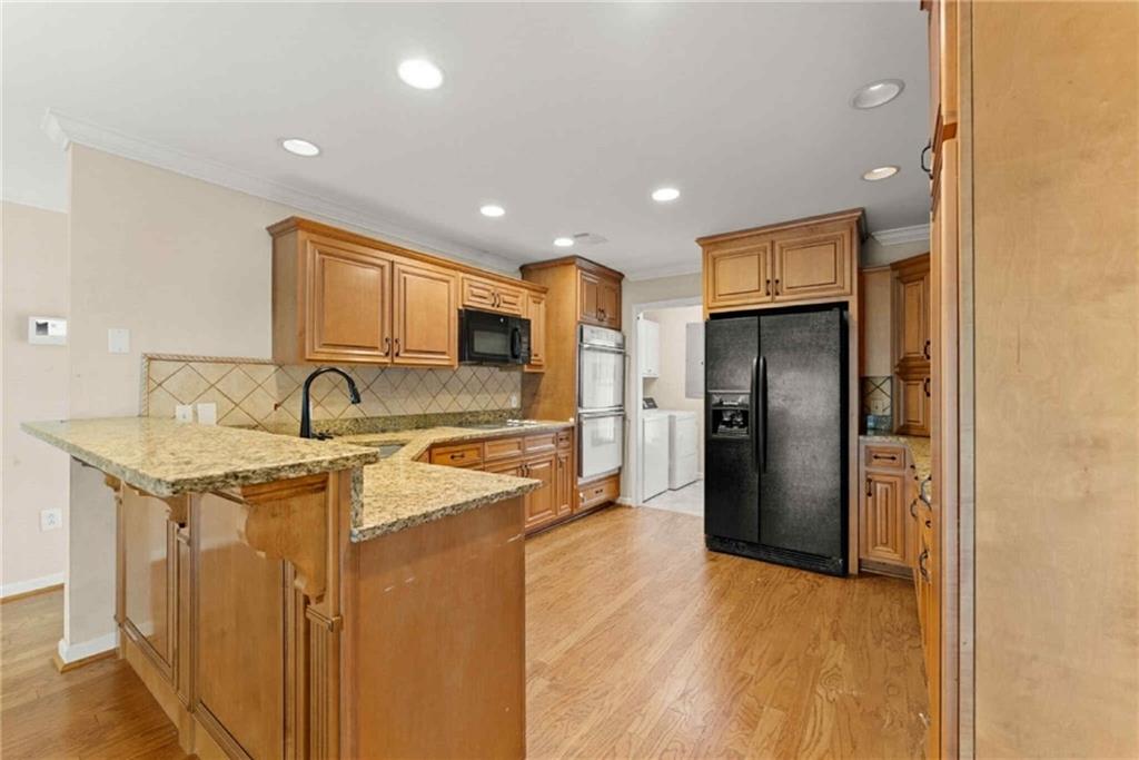 749 Hubert Pittman Road Pendergrass, GA 30567 - Photo 13 of 49 a kitchen with stainless steel appliances granite countertop a refrigerator and a sink