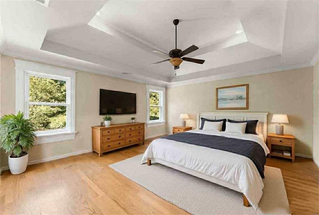 749 Hubert Pittman Road Pendergrass, GA 30567 - Photo 19 of 49 a spacious bedroom with a bed and a flat screen tv