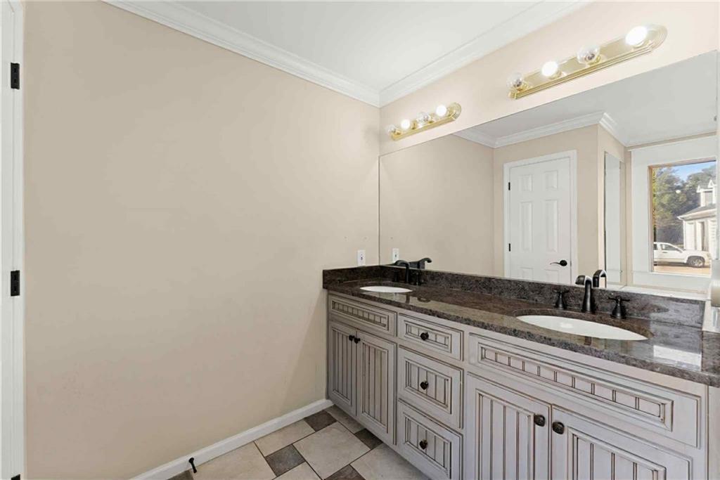 749 Hubert Pittman Road Pendergrass, GA 30567 - Photo 21 of 49 a bathroom with a granite countertop sink and a mirror
