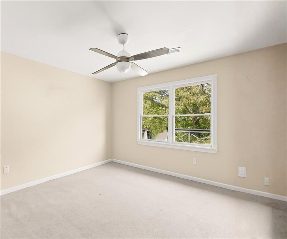 749 Hubert Pittman Road Pendergrass, GA 30567 - Photo 22 of 49 an empty room with a window and a fan