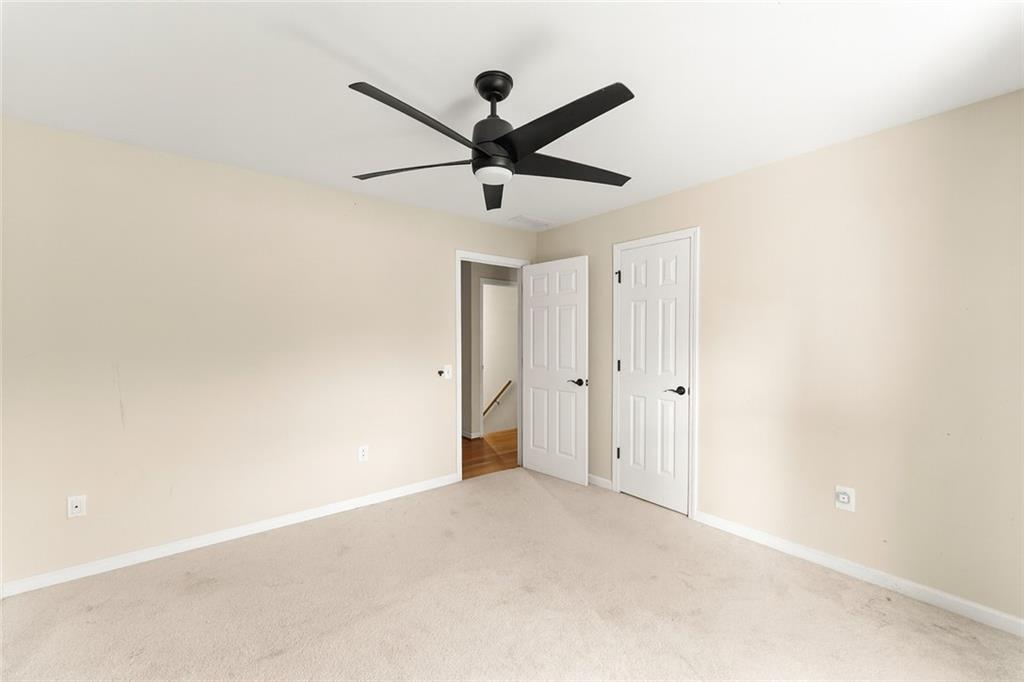 749 Hubert Pittman Road Pendergrass, GA 30567 - Photo 24 of 49 a view of empty room with a ceiling fan