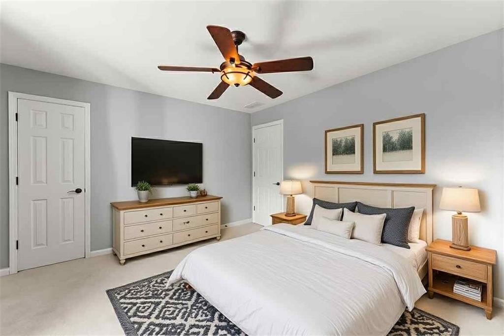 749 Hubert Pittman Road Pendergrass, GA 30567 - Photo 26 of 49 a bedroom with furniture and flat screen tv