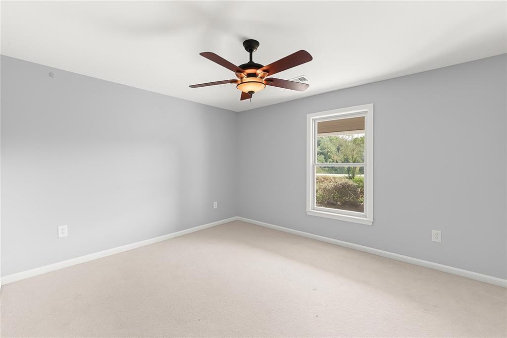 749 Hubert Pittman Road Pendergrass, GA 30567 - Photo 27 of 49 an empty room with windows and fan