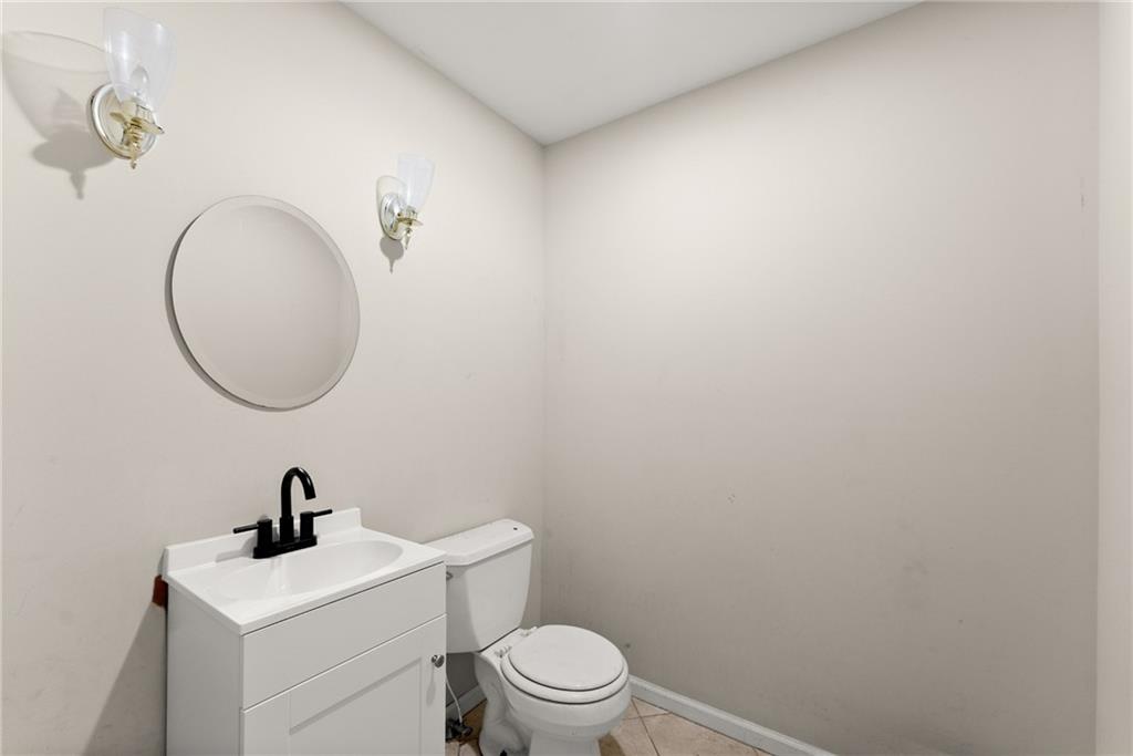 749 Hubert Pittman Road Pendergrass, GA 30567 - Photo 28 of 49 a bathroom with a toilet a sink and a mirror