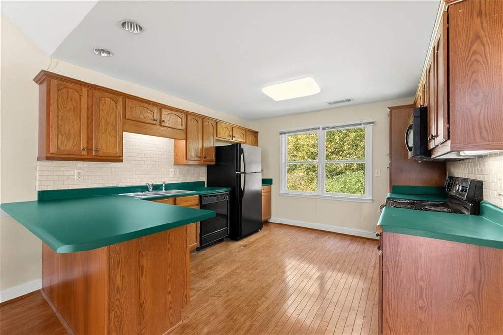 749 Hubert Pittman Road Pendergrass, GA 30567 - Photo 41 of 49 a kitchen with stainless steel appliances granite countertop a sink a stove and a microwave