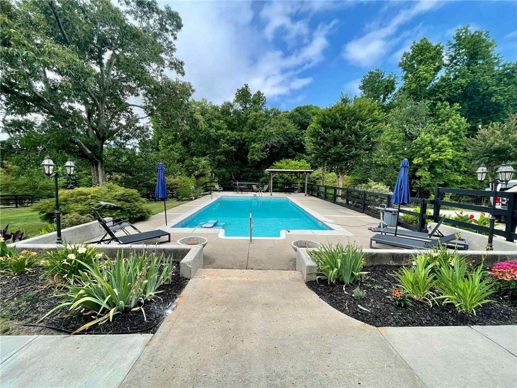 749 Hubert Pittman Road Pendergrass, GA 30567 - Photo 44 of 49 a view of a swimming pool with a patio