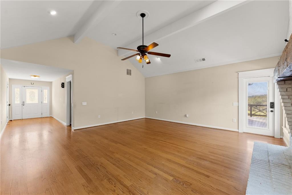 749 Hubert Pittman Road Pendergrass, GA 30567 - Photo 9 of 49 a view of an empty room with window and wooden floor