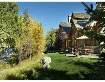 a backyard of a house with yard and outdoor seating