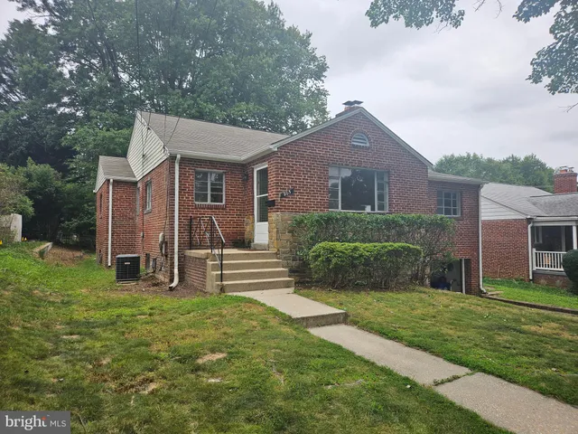 a view of a house with a yard and a large tree center with large windows