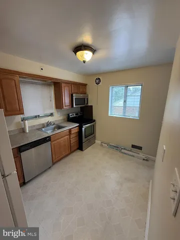 a kitchen with a sink a stove and cabinets