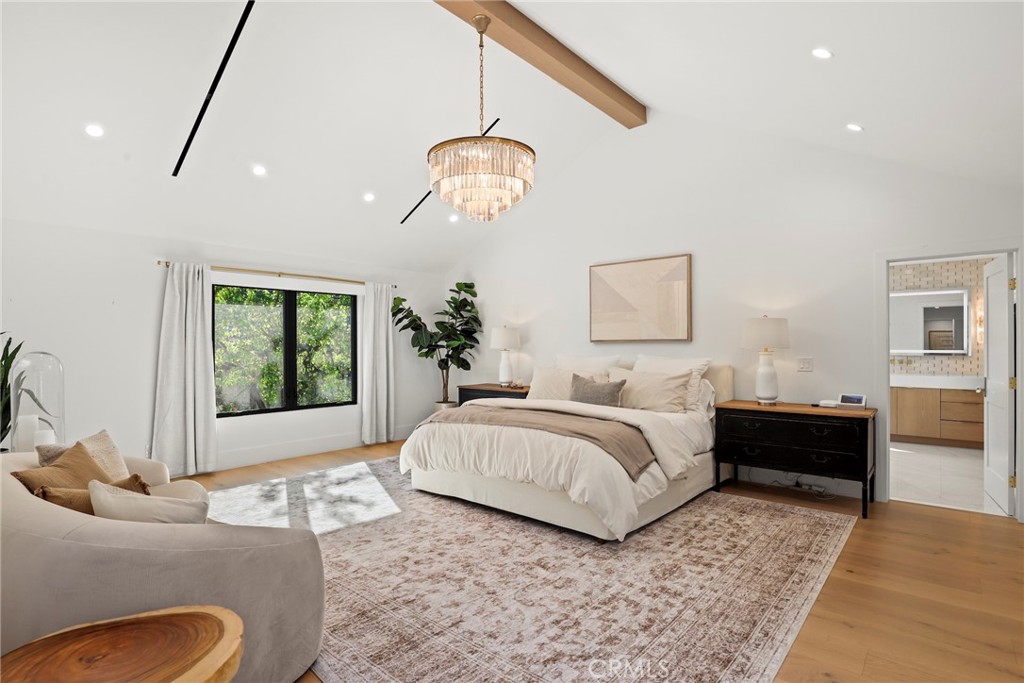 20630 Kingsboro Way Woodland Hills, CA 91364 - Photo 18 of 44 a spacious bedroom with a bed mirror and a window