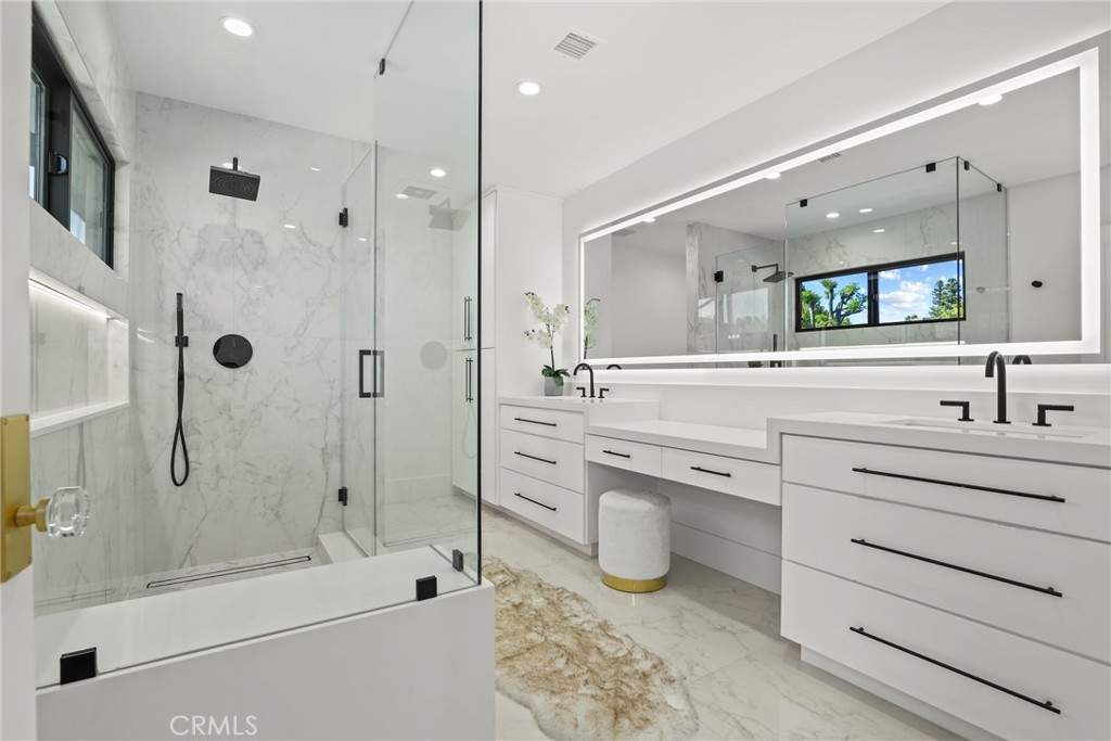 20630 Kingsboro Way Woodland Hills, CA 91364 - Photo 28 of 44 a bathroom with a shower sink and mirror