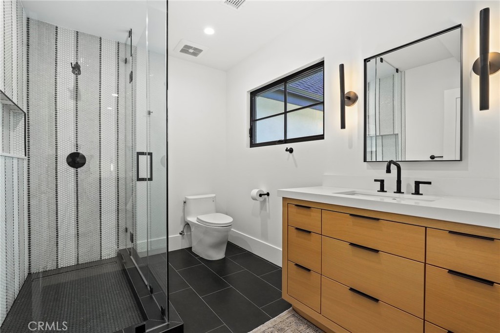 20630 Kingsboro Way Woodland Hills, CA 91364 - Photo 30 of 44 a bathroom with a toilet sink and mirror