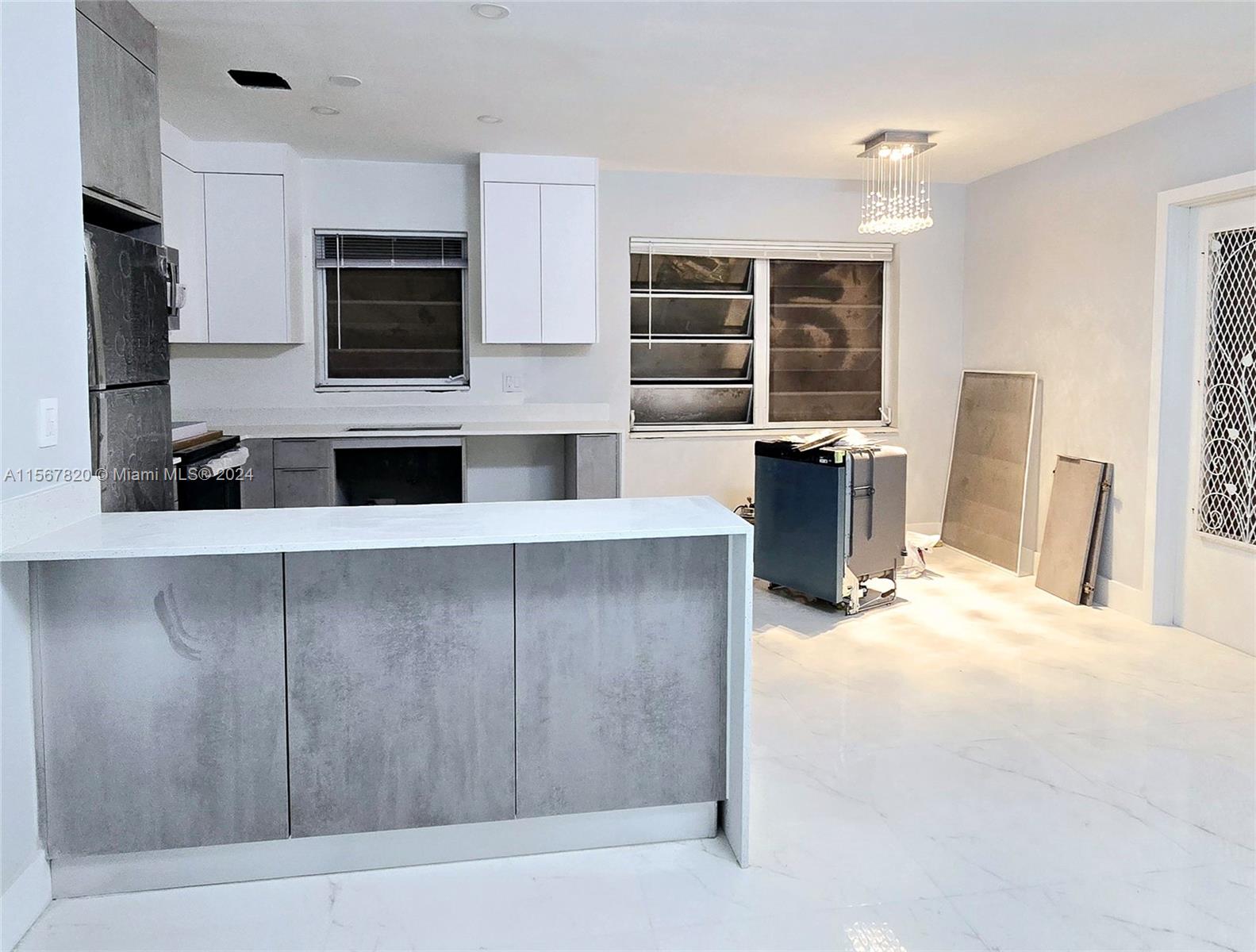 a kitchen with stainless steel appliances a microwave and refrigerator