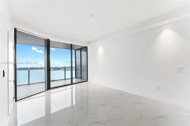 an empty room with windows and closet