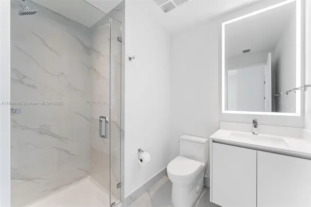 a bathroom with a toilet sink and shower